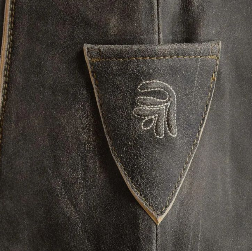 Pocket close-up with delicate Bavarian embroidery.